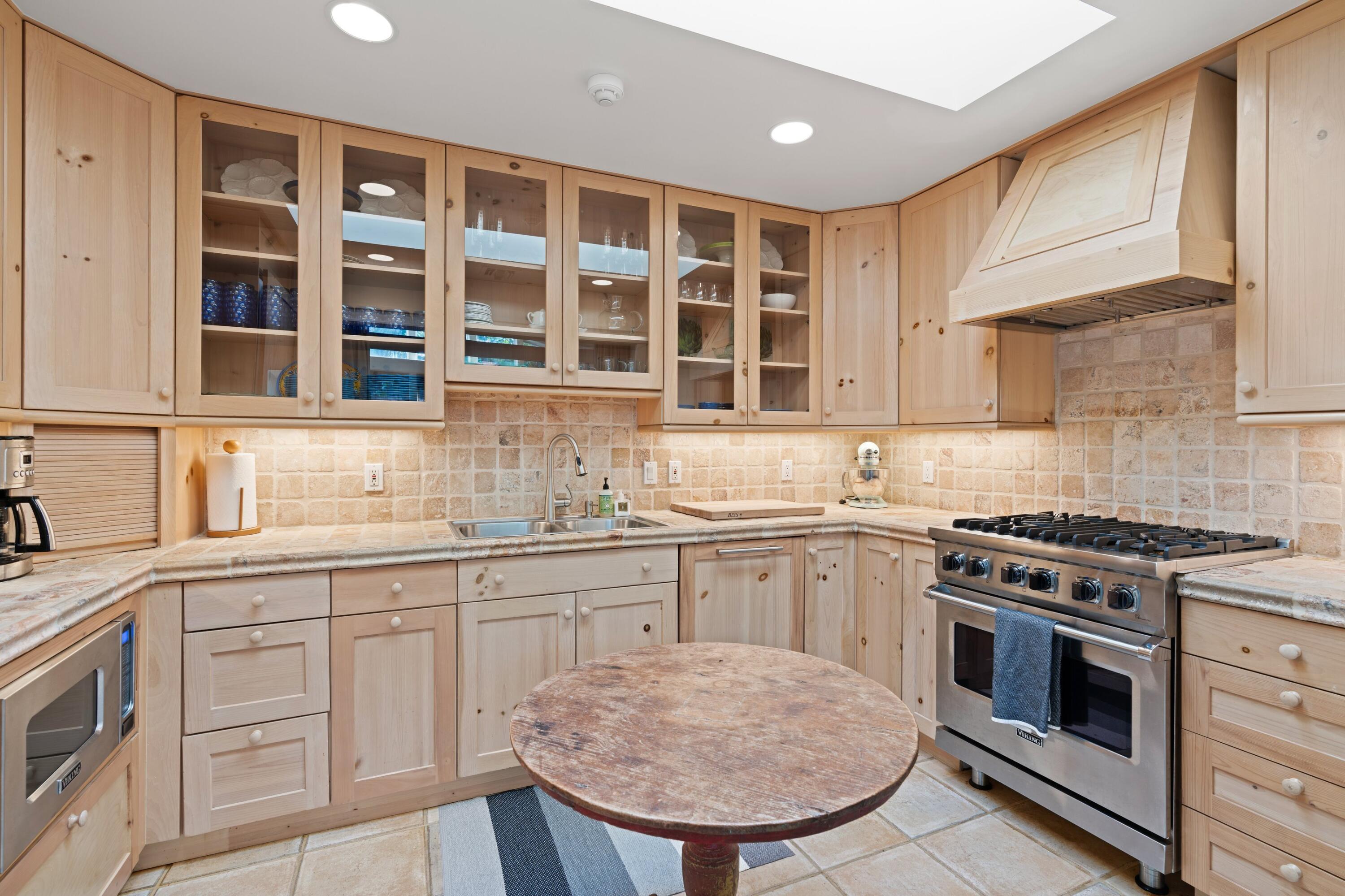 240 Celestial Way, Unit 10 Juno Beach, FL 33408 - Photo 19 of 40 a kitchen with cabinets appliances and a sink