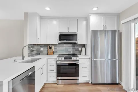 a kitchen with a sink stove and refrigerator