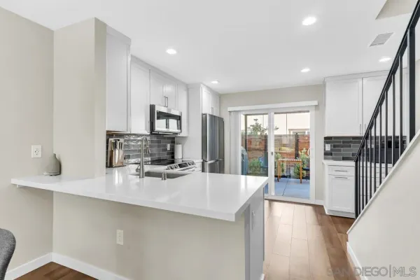a kitchen with counter top space cabinets and stainless steel appliances