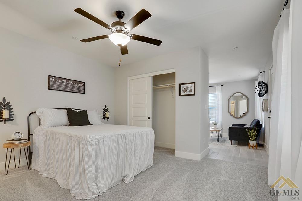 Undisclosed Address Bakersfield, CA 93311 - Photo 11 of 28 a bedroom with a bed and a chandelier