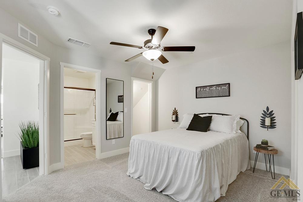 Undisclosed Address Bakersfield, CA 93311 - Photo 12 of 28 a bedroom with a bed and a chandelier