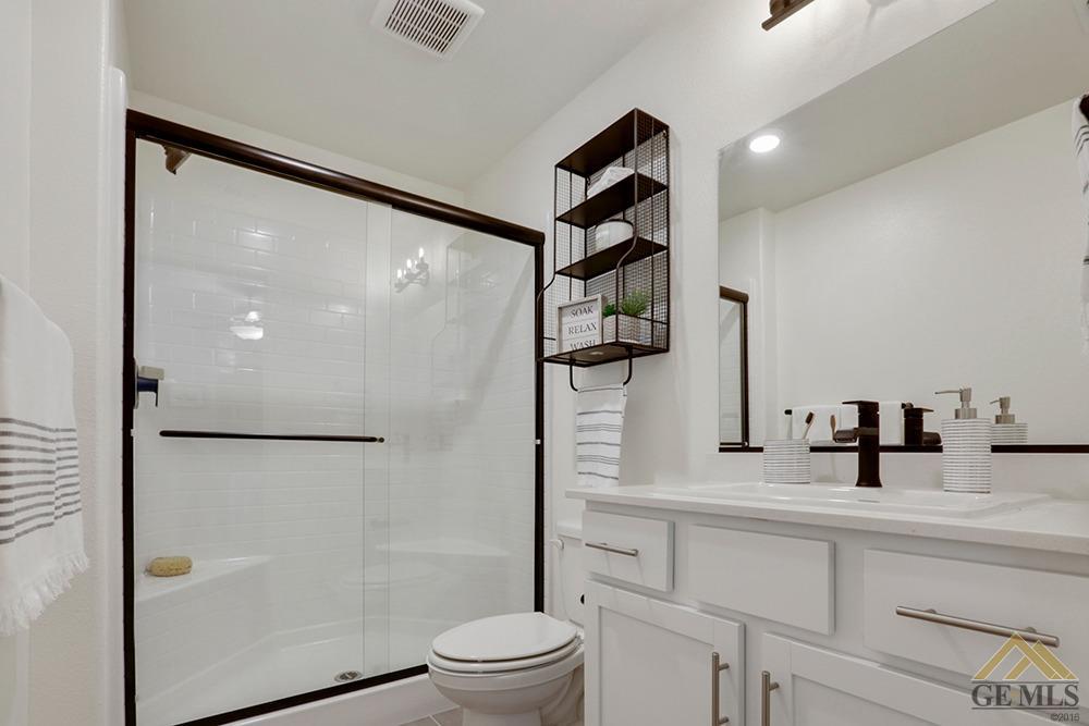 Undisclosed Address Bakersfield, CA 93311 - Photo 15 of 28 a bathroom with a shower toilet and sink