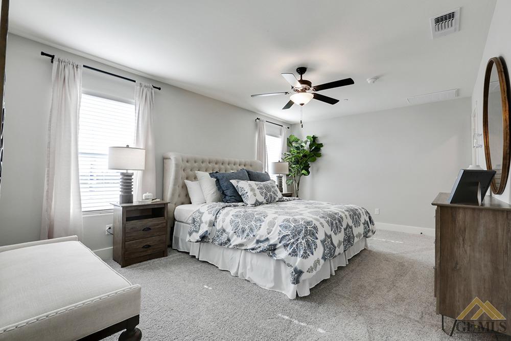 Undisclosed Address Bakersfield, CA 93311 - Photo 17 of 28 a bedroom with bed and a chandelier