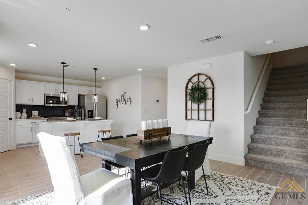 Undisclosed Address Bakersfield, CA 93311 - Photo 5 of 28 a living room with furniture a flat screen tv and kitchen view