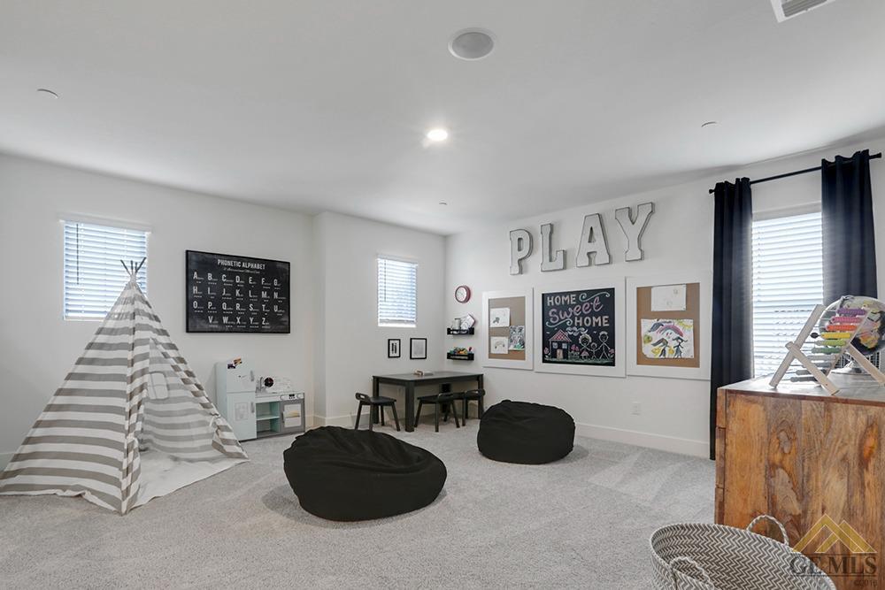 Undisclosed Address Bakersfield, CA 93311 - Photo 10 of 28 a living room with furniture and a flat screen tv
