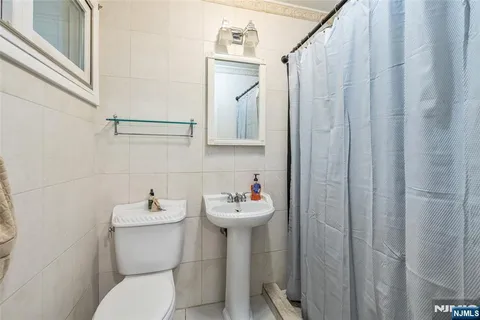 a bathroom with a sink mirror and toilet
