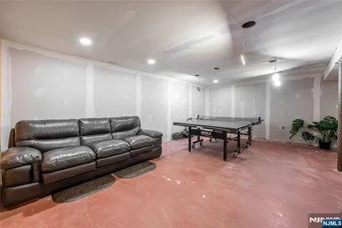 a living room with furniture and a dining table with kitchen view