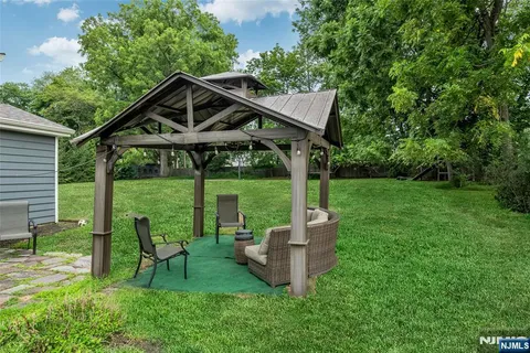 a view of a chair and table in the garden
