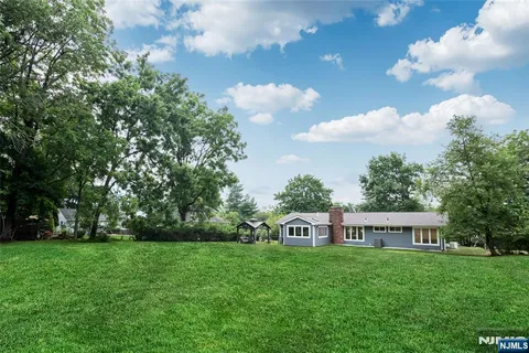 a view of a house with a backyard
