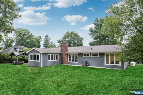 a view of a house with a backyard