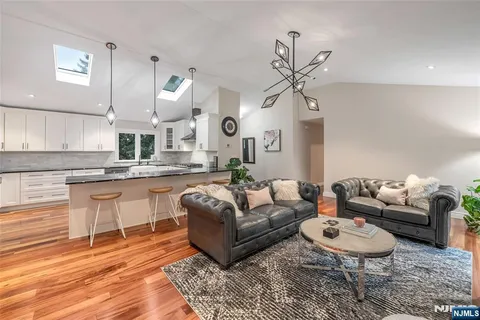 a living room with granite countertop furniture a rug and white walls