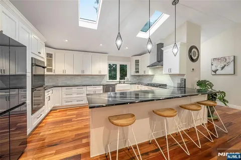 a large kitchen with granite countertop lots of counter space and window