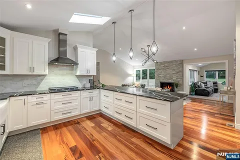 a kitchen with granite countertop white cabinets and white appliances