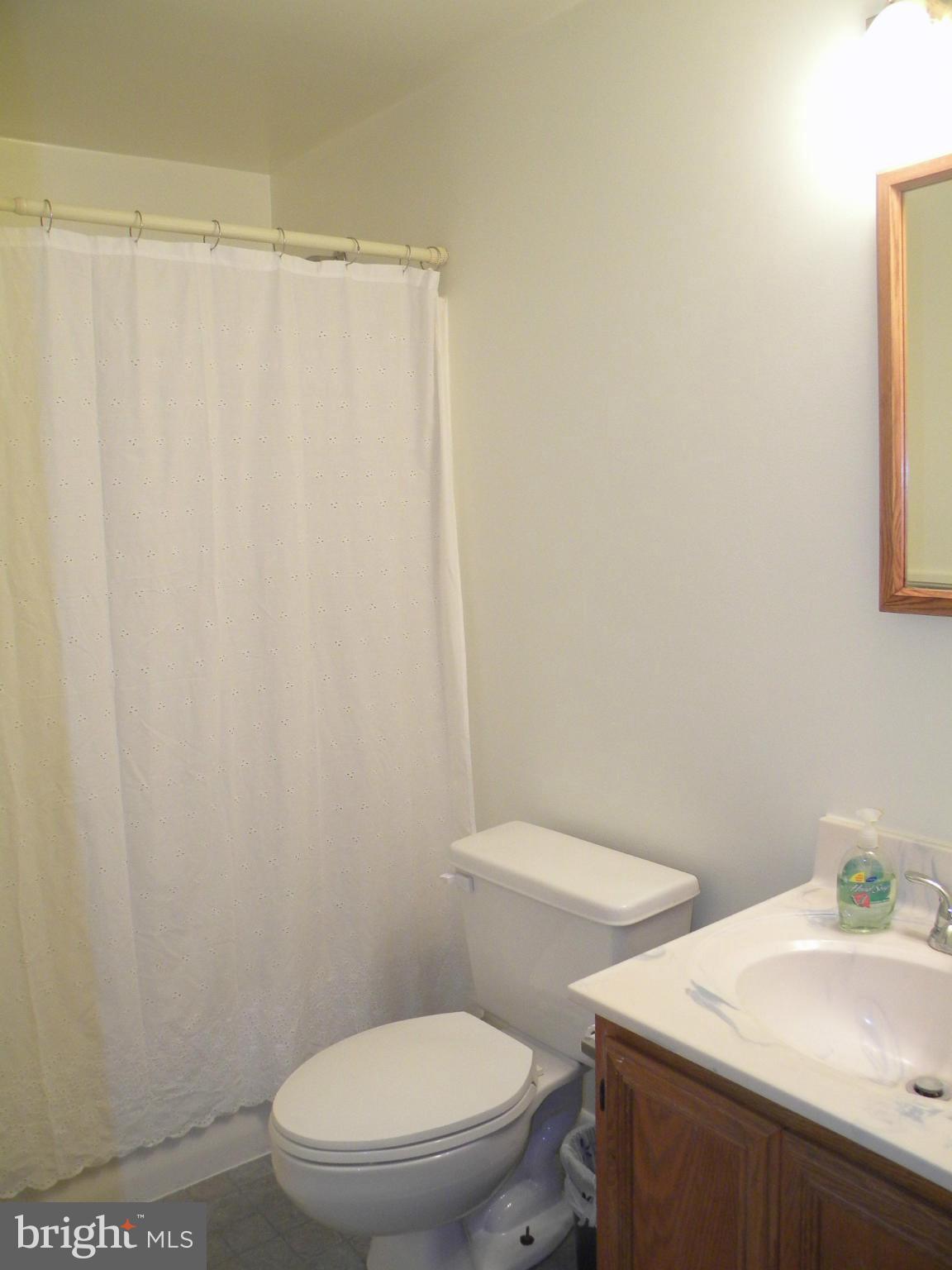 818 Ridge Court Lusby, MD 20657 - Photo 10 of 18 a white toilet sitting next to a bathroom sink