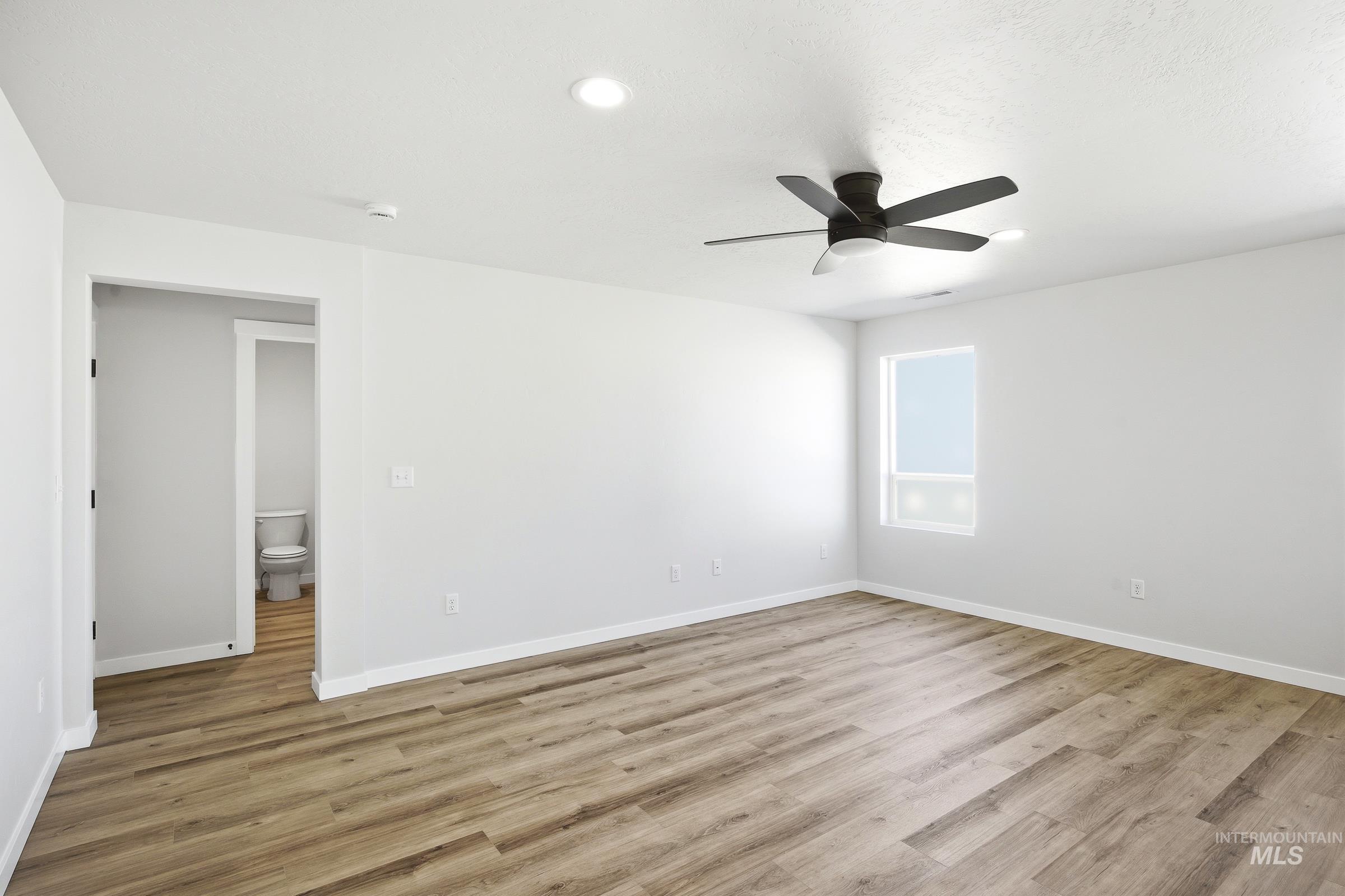 12841 Decatur Street Nampa, ID 83651 - Photo 9 of 30 Spacious room featuring wood-finish flooring, recessed lighting, and a modern ceiling fan