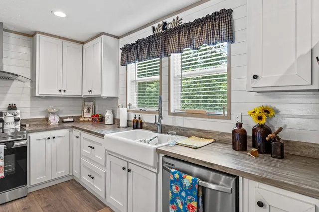 a kitchen with a sink cabinets and window