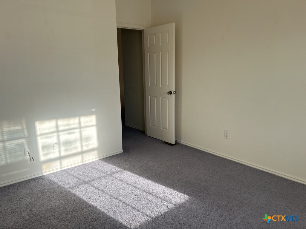 4005 Doraine Court, Unit A Killeen, TX 76549 - Photo 8 of 9 an empty room with windows