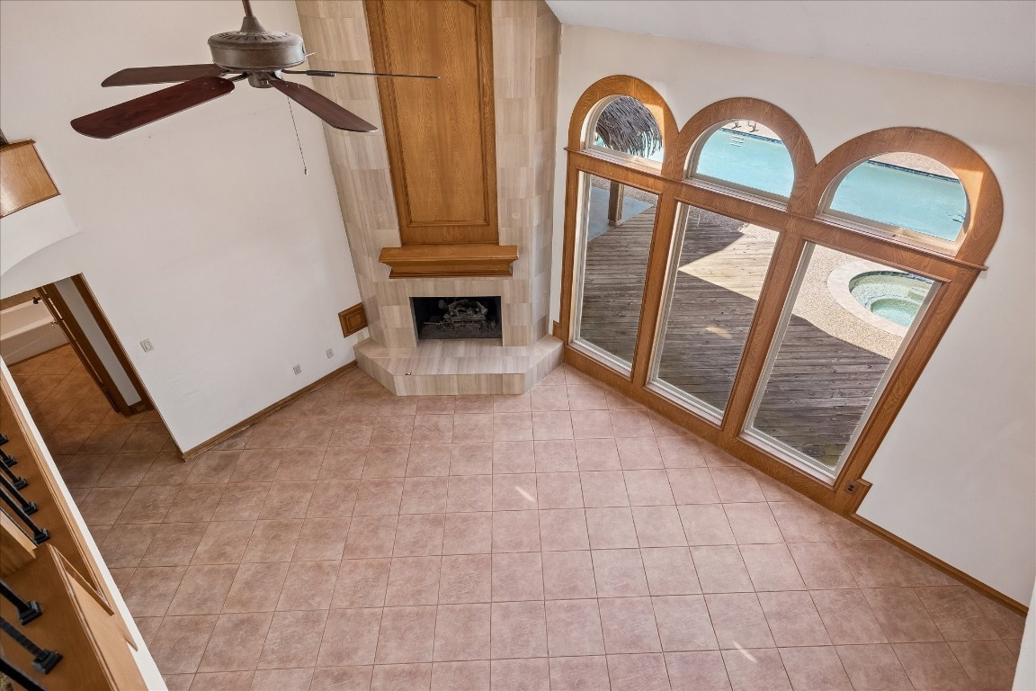 1835 Raintree Circle Seabrook, TX 77586 - Photo 11 of 50 The floor to ceiling tile surround fireplace is stunning alongside the large windows.