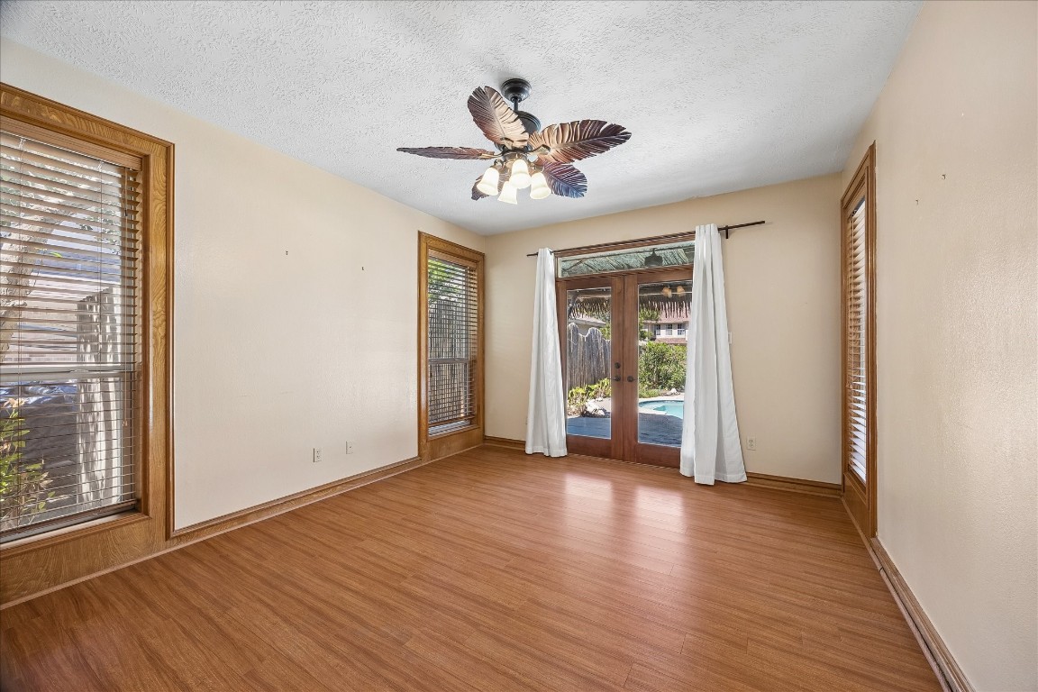 1835 Raintree Circle Seabrook, TX 77586 - Photo 13 of 50 a view of an empty room with a window and wooden floor