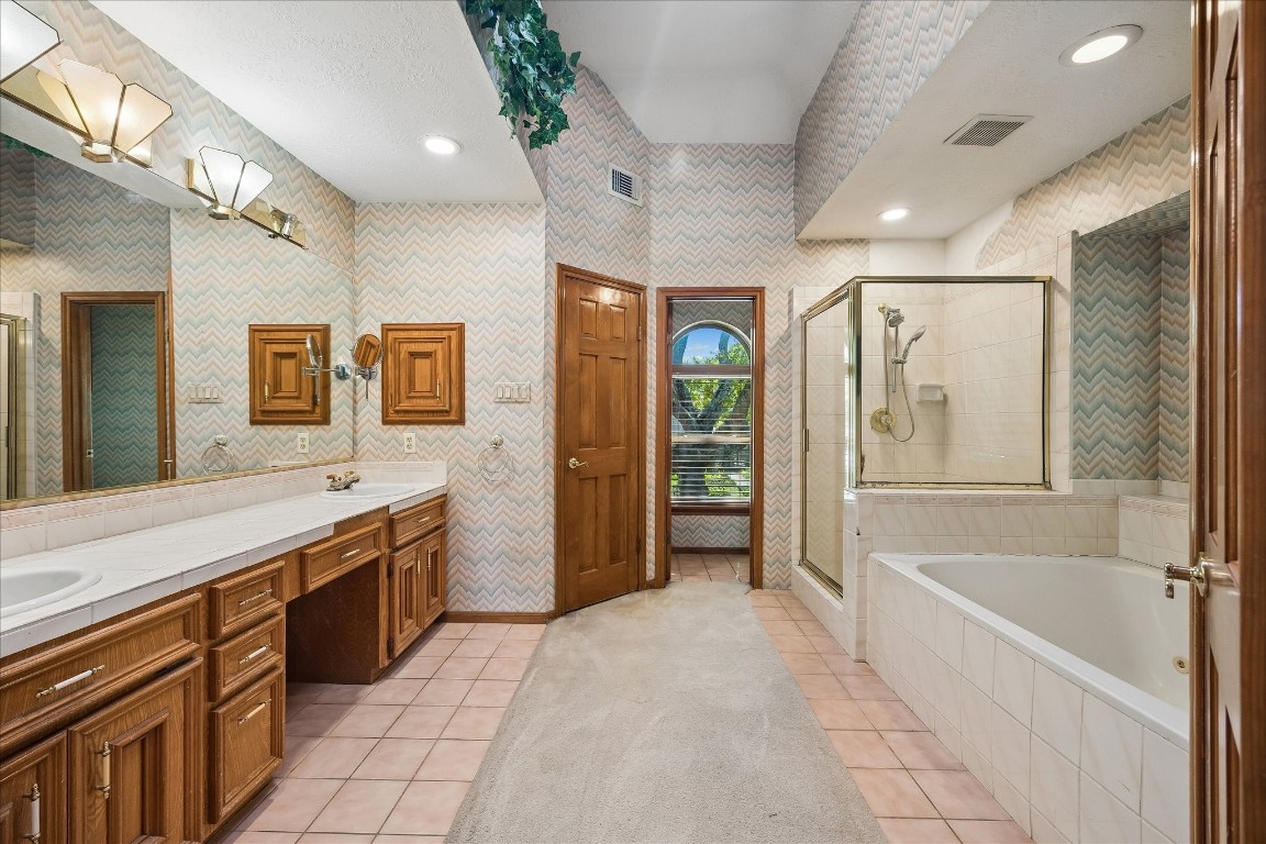 1835 Raintree Circle Seabrook, TX 77586 - Photo 19 of 50 a spacious bathroom with a granite countertop tub sink shower and mirror