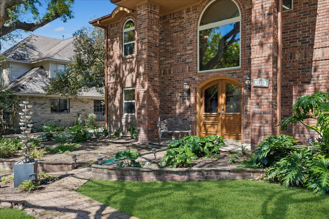 1835 Raintree Circle Seabrook, TX 77586 - Photo 2 of 50 a front view of a house with a garden