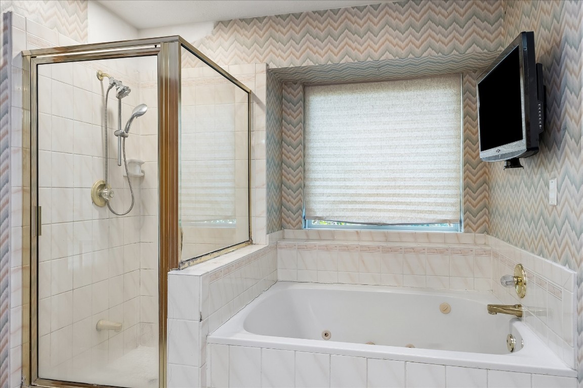 1835 Raintree Circle Seabrook, TX 77586 - Photo 21 of 50 a bathroom with a bathtub and a shower