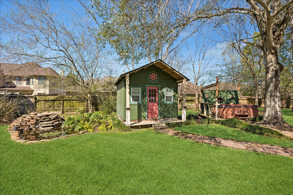 1835 Raintree Circle Seabrook, TX 77586 - Photo 36 of 50 a front view of a house with a garden and trees