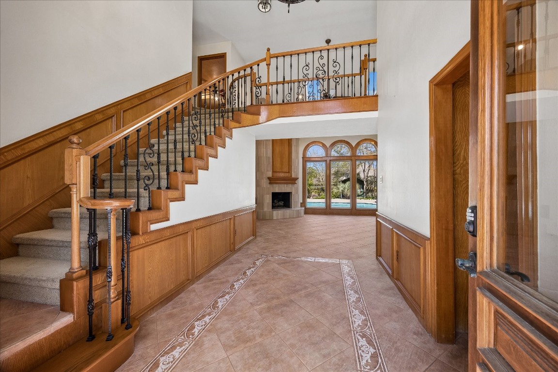 1835 Raintree Circle Seabrook, TX 77586 - Photo 4 of 50 Stunning front entry with tile and wrought iron spindles and floor to ceiling tile fireplace. The lovely wood trim provides character and charm.