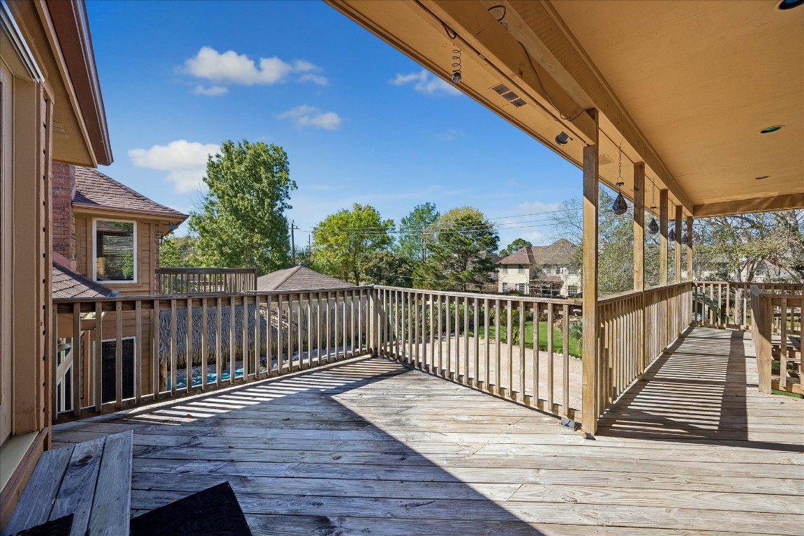 1835 Raintree Circle Seabrook, TX 77586 - Photo 42 of 50 a view of deck with wooden floor and fence with a large tree