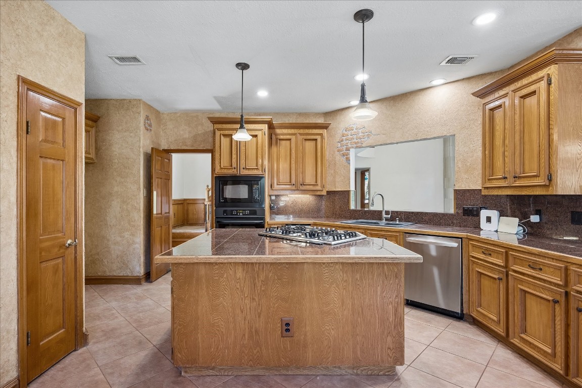1835 Raintree Circle Seabrook, TX 77586 - Photo 6 of 50 a kitchen with stainless steel appliances granite countertop a sink a stove a refrigerator a center island and cabinets