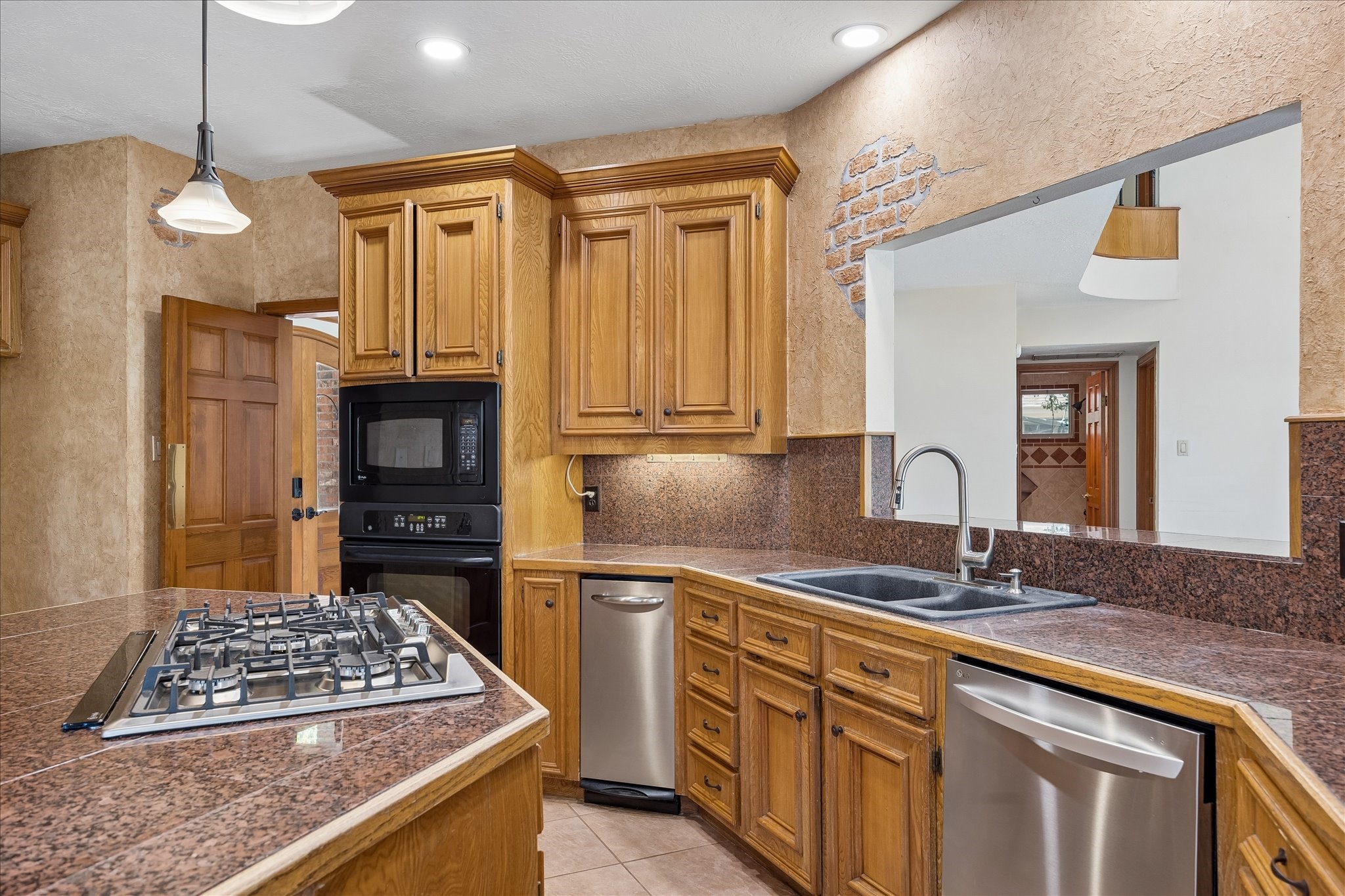 1835 Raintree Circle Seabrook, TX 77586 - Photo 9 of 50 a kitchen with stainless steel appliances granite countertop a sink stove and refrigerator