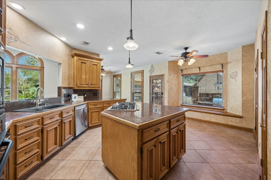 1835 Raintree Circle Seabrook, TX 77586 - Photo 10 of 50 a kitchen with stainless steel appliances granite countertop a sink and a stove