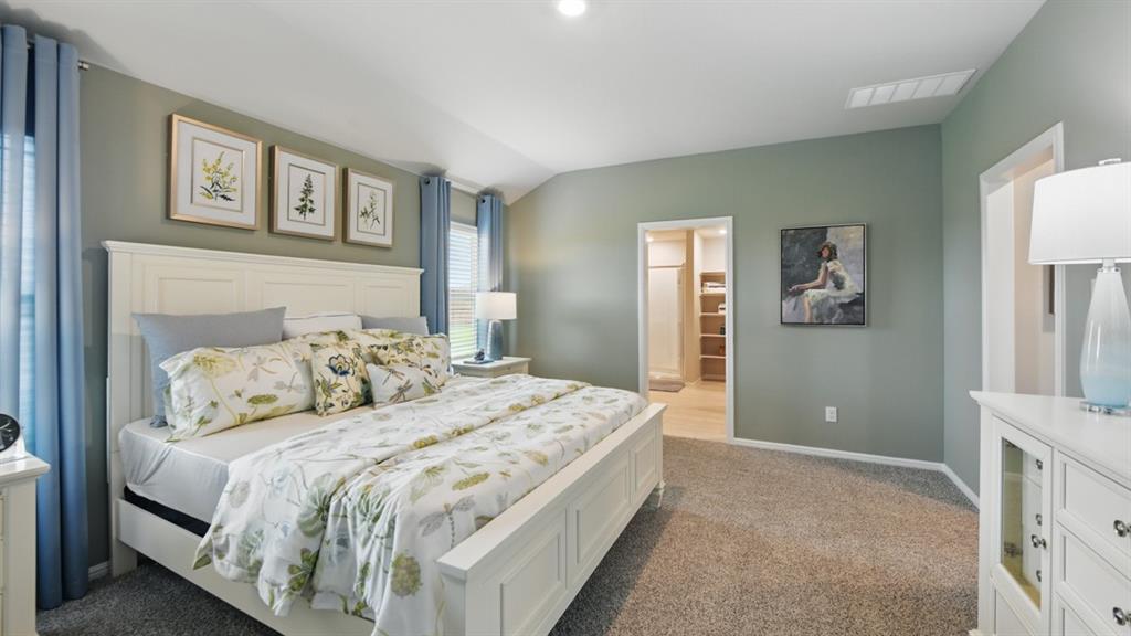 1645 Tin Roof Road Krum, TX 76249 - Photo 16 of 36 a bedroom with a bed and a painting on the wall