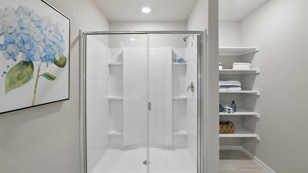 1645 Tin Roof Road Krum, TX 76249 - Photo 18 of 36 a bathroom with a glass shower door