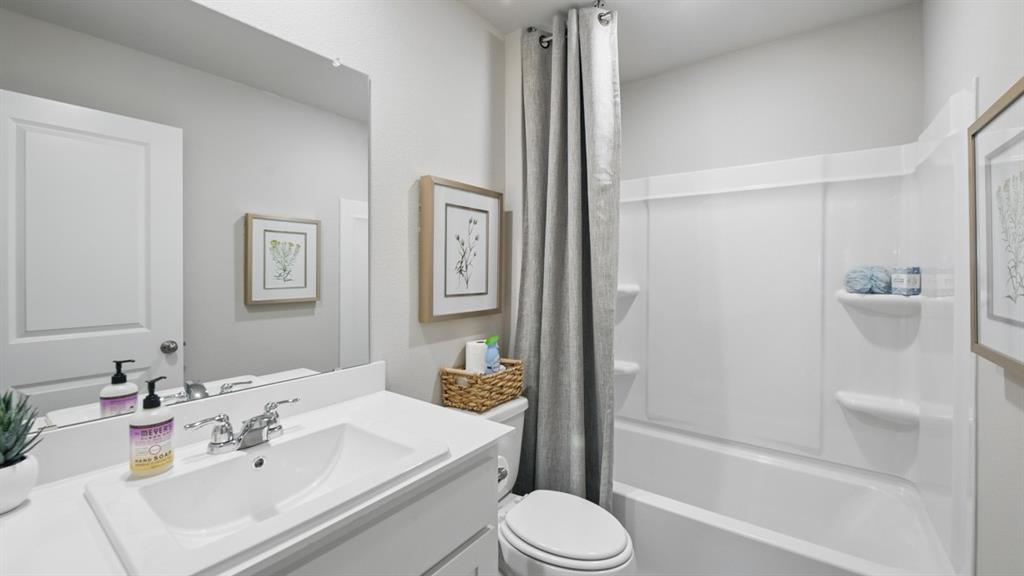 1645 Tin Roof Road Krum, TX 76249 - Photo 30 of 36 a bathroom with a sink toilet and shower