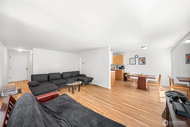 a living room with furniture and wooden floor
