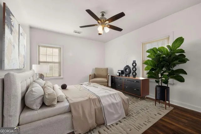 a bedroom with a bed and a potted plant