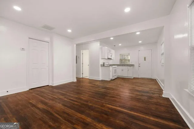a view of kitchen with kitchen island sink and refrigerator