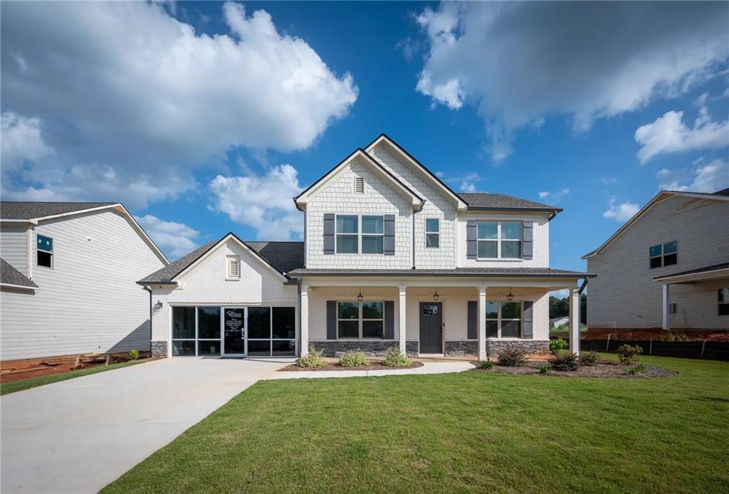 a front view of a house with a garden