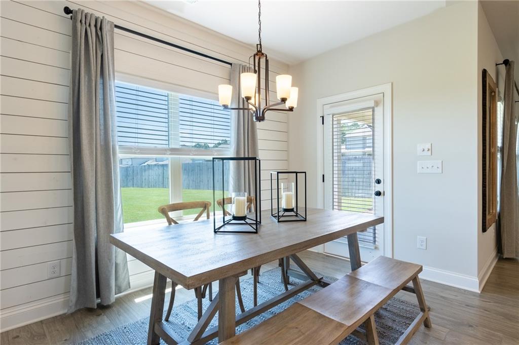 560 Calgary Downs Drive Winder, GA 30680 - Photo 12 of 37 a view of a dining room with furniture window and wooden floor
