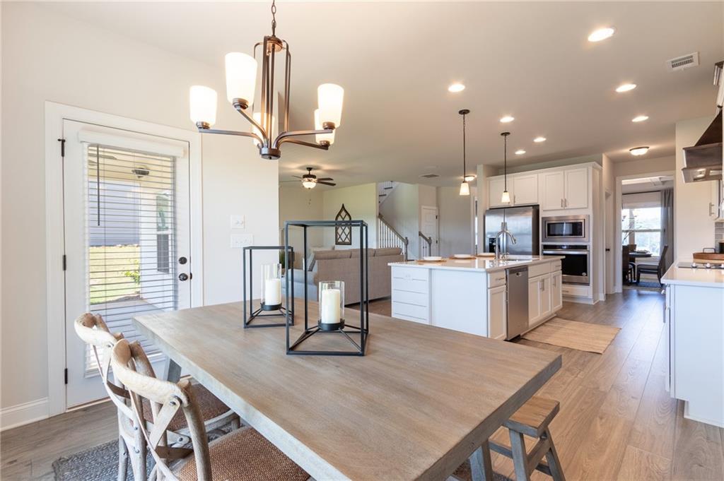 560 Calgary Downs Drive Winder, GA 30680 - Photo 13 of 37 a view of a dining room with furniture