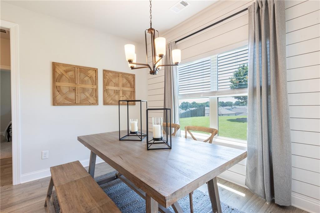 560 Calgary Downs Drive Winder, GA 30680 - Photo 14 of 37 a view of a dining room with furniture window and wooden floor
