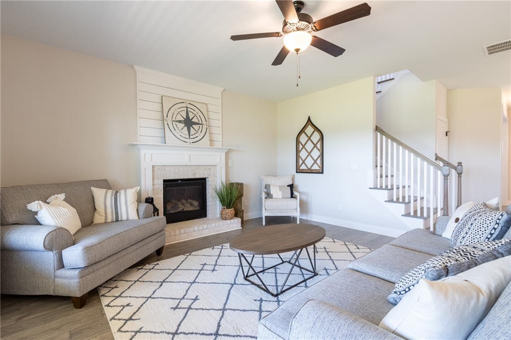 560 Calgary Downs Drive Winder, GA 30680 - Photo 15 of 37 a living room with furniture and a fireplace