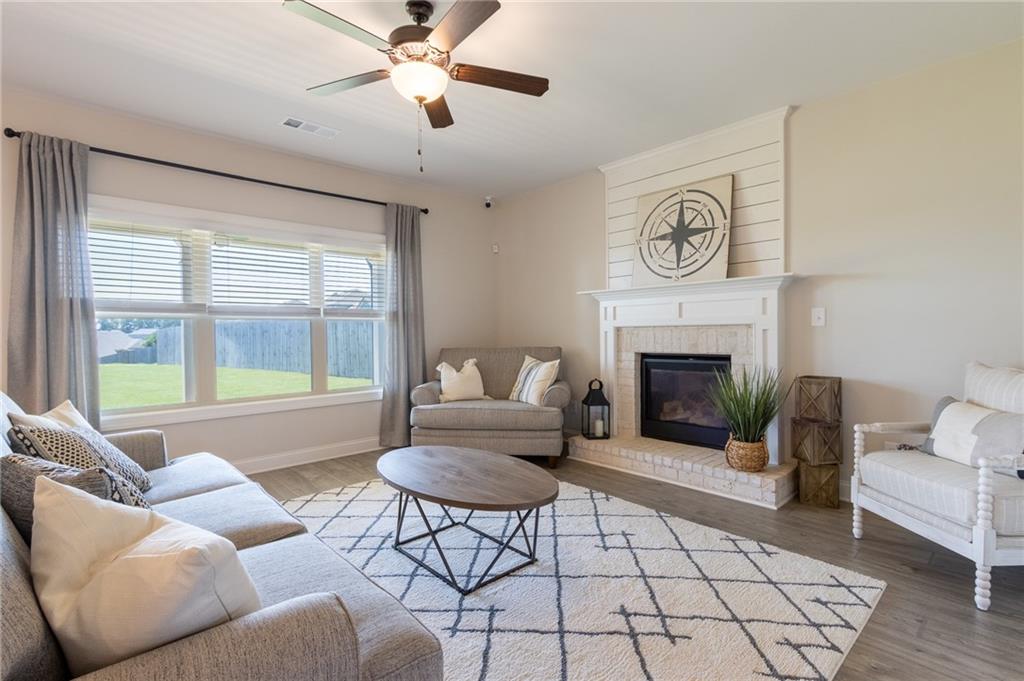 560 Calgary Downs Drive Winder, GA 30680 - Photo 17 of 37 a living room with furniture and a fireplace