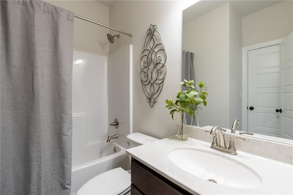 560 Calgary Downs Drive Winder, GA 30680 - Photo 18 of 37 a bathroom with a sink toilet and shower