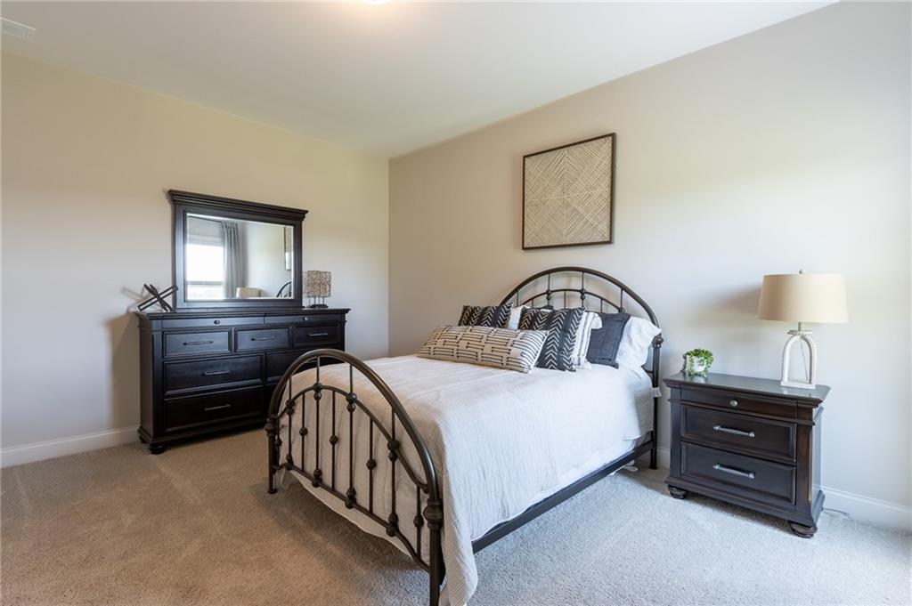 560 Calgary Downs Drive Winder, GA 30680 - Photo 20 of 37 a bedroom with a bed and a dresser