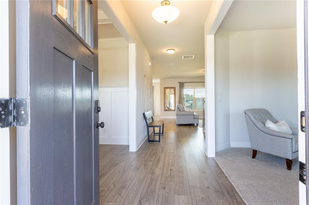 560 Calgary Downs Drive Winder, GA 30680 - Photo 2 of 37 a living room with furniture and a wooden floor