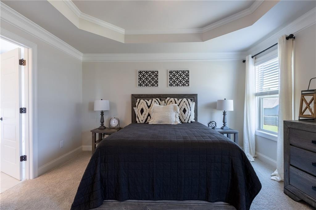 560 Calgary Downs Drive Winder, GA 30680 - Photo 23 of 37 a bedroom with a bed and a painting on the wall