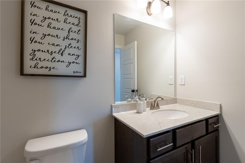 560 Calgary Downs Drive Winder, GA 30680 - Photo 34 of 37 a bathroom with a sink a toilet and a mirror