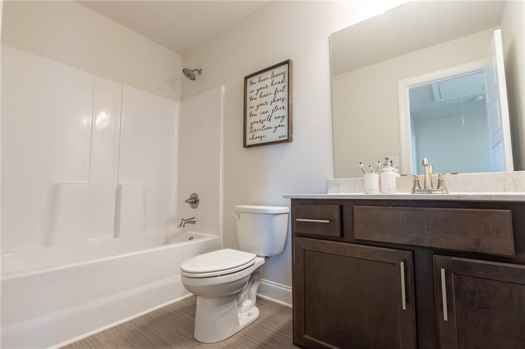 560 Calgary Downs Drive Winder, GA 30680 - Photo 35 of 37 a bathroom with a sink a toilet and shower